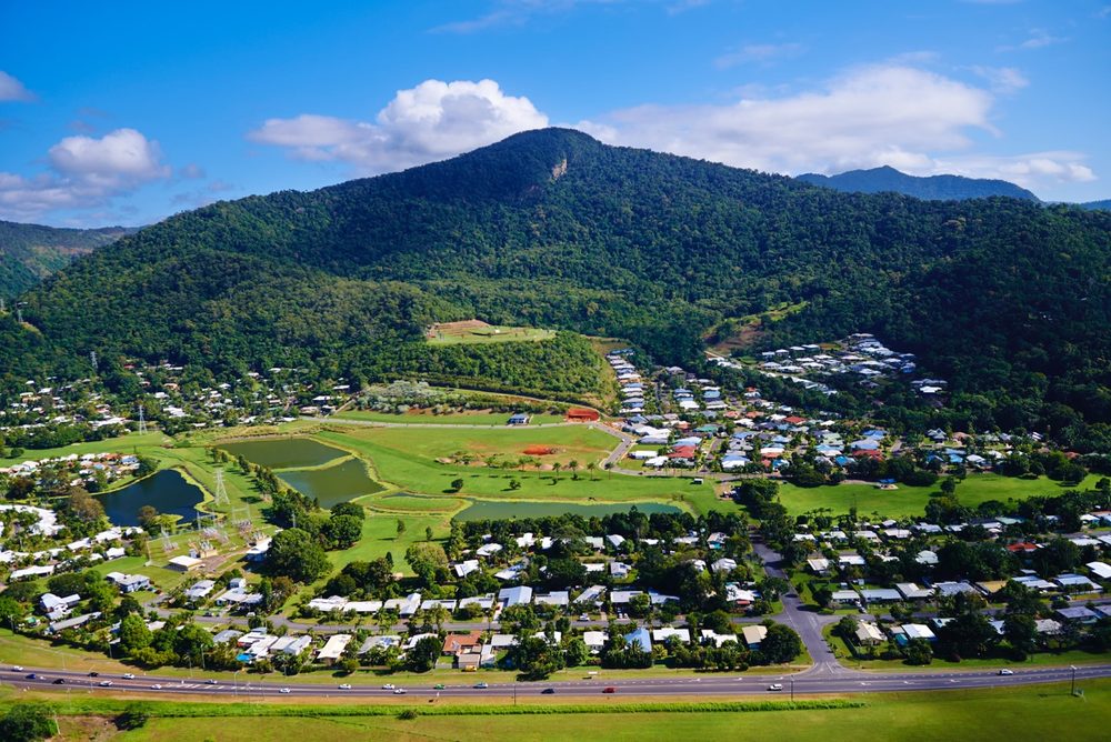 Aerial view of Red Peak Forest Estate beneath Red Peak Mountain, with lakes, parkland and homes